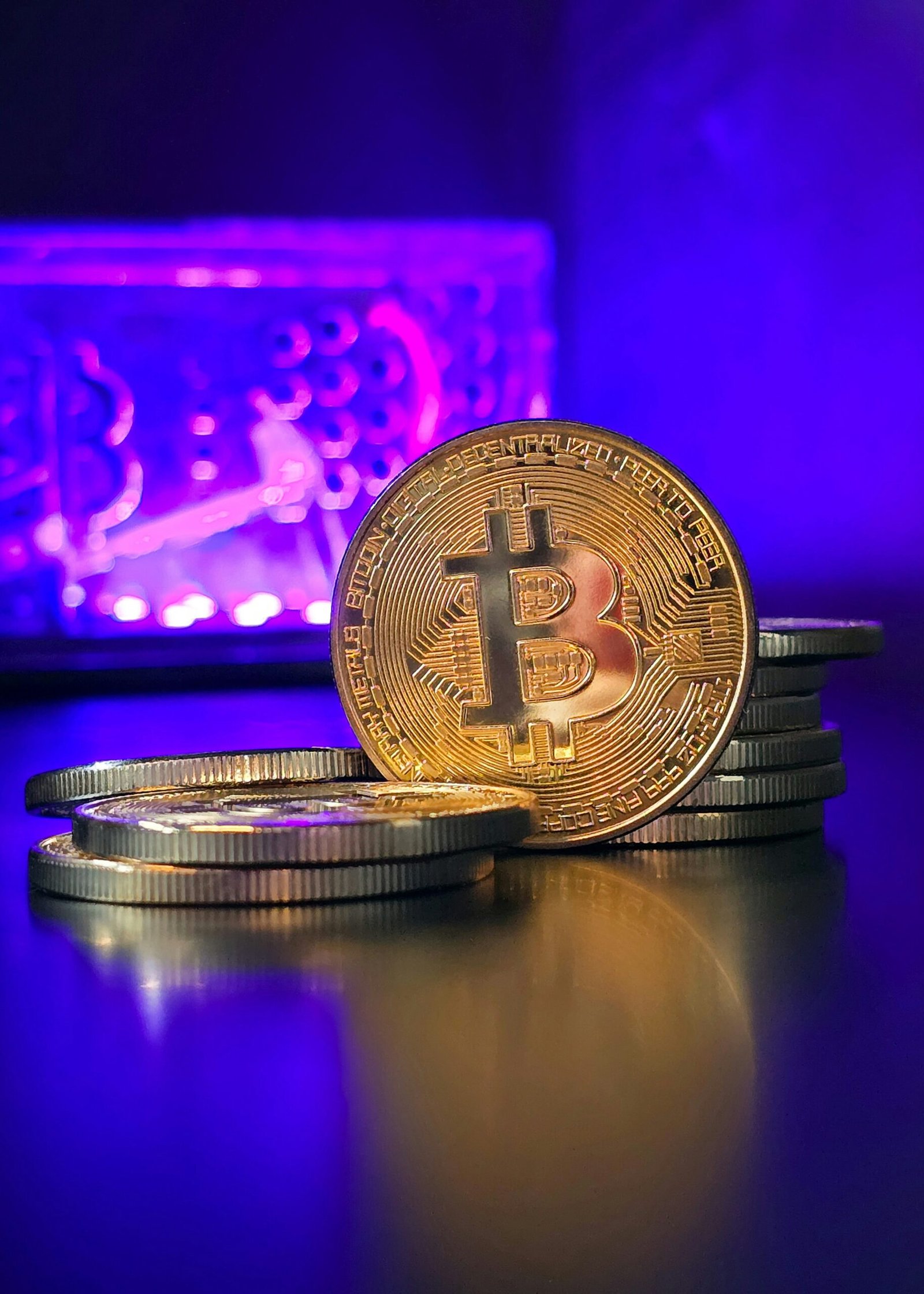 a stack of gold bitcoins sitting on top of a table